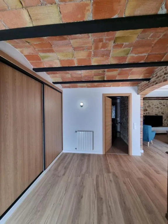 Hallway with a built-in wooden wardrobe under the tile vault